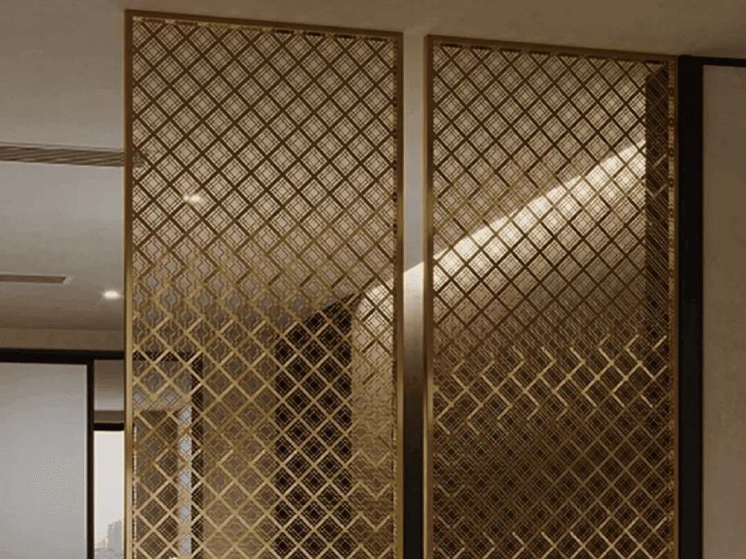 Two elegant gold-finished metal room dividers featuring an intricate geometric lattice pattern in a modern interior
