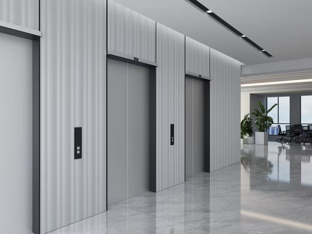 Modern office hallway with grey elevators, fluted wall panels, and polished marble floors. Minimalist design
