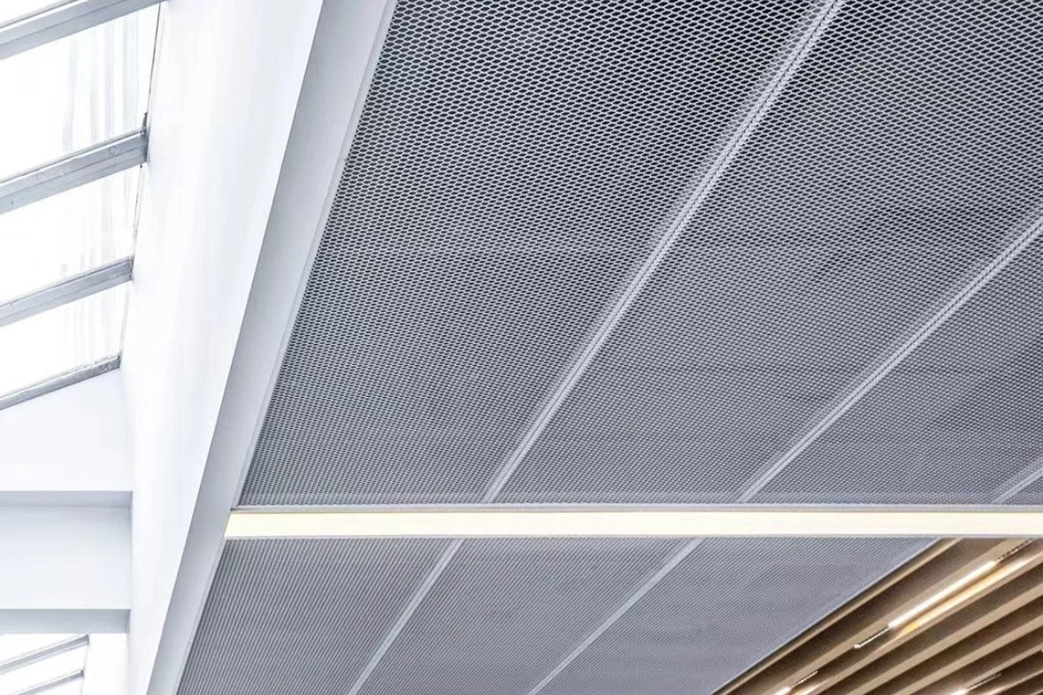 Expanded metal ceiling system with modern design featuring a grid pattern and light fixtures.