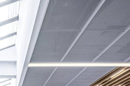 Expanded metal ceiling system with modern design featuring a grid pattern and light fixtures.